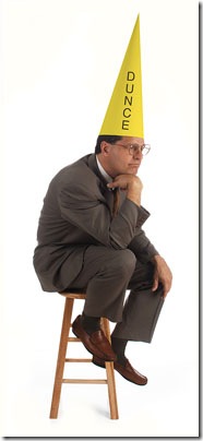 Wearing a Dunce Hat as a Dum Dum after realizing how his employee selection process was inadequate